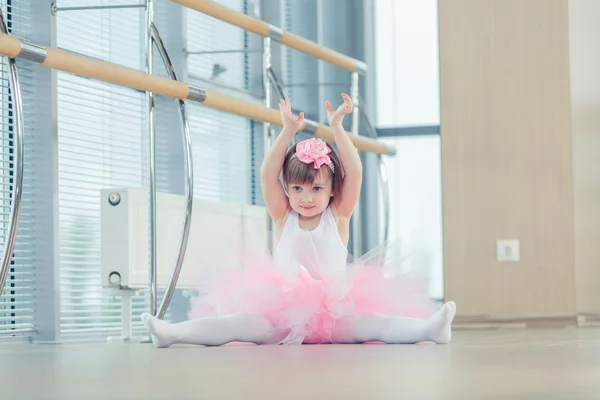 Adorable child dancing classical ballet in studio.