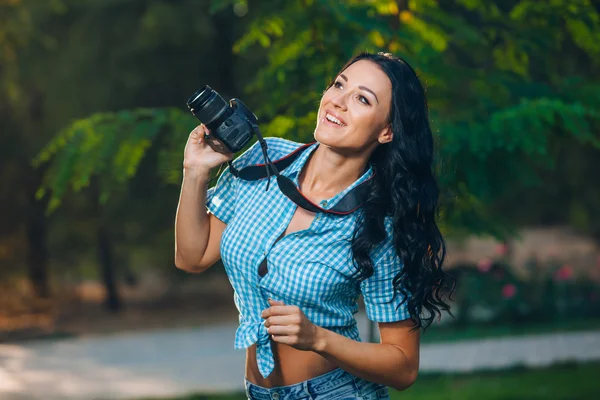Young woman photographer taking photo outdoor