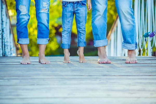 Happy Family on a Walk in Summer. Child with Parents Together. Feet Barefoot. Healthy Lifestyle. Dad Mom and Son. Spring Time