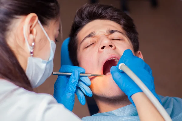 Dentist treatment a patients teeth in the dentist.