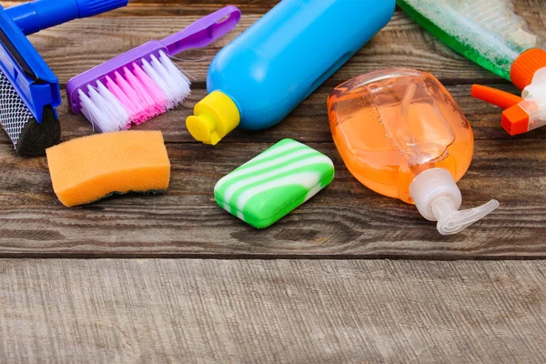 Cleaning products on wooden background.