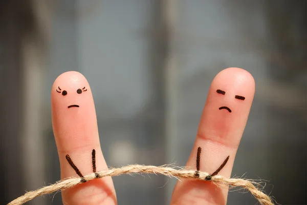 Finger art of couple. Woman and man pull rope. Couple quarreled, cannot solve the problem, a misunderstanding.