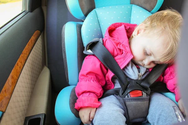 Little girl sleeping in child car seat.