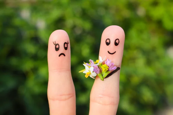 Finger art of couple. Joyful man gives a woman a bouquet of flowers, it is not satisfied.