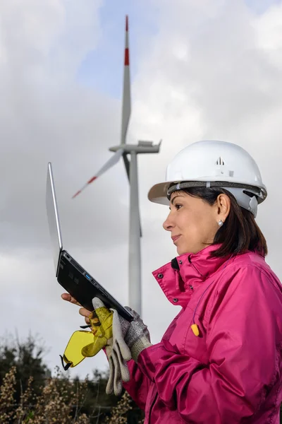 Woman engineer checking wind turbines.
