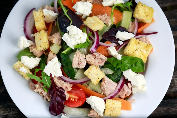 Tuna salad with Spinach, rocket, red ruby chard, tomatoes, cucumbers, white cheese, carrot, red onion, croutons. background.