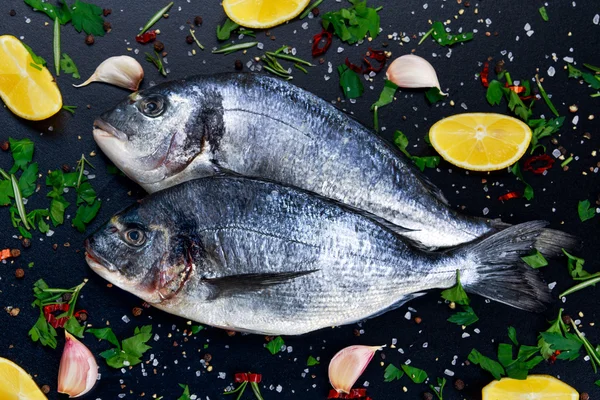 Fresh Raw Sea Bream Fish on blue stone background