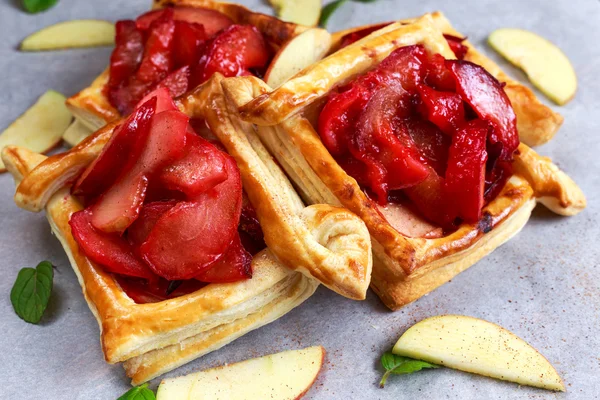 Puff pastry pies with plums, apples, mint and honey