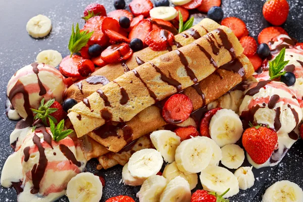 Sweet Rolled Pancakes with nutella, strawberry, blueberry, banana, ice cream.