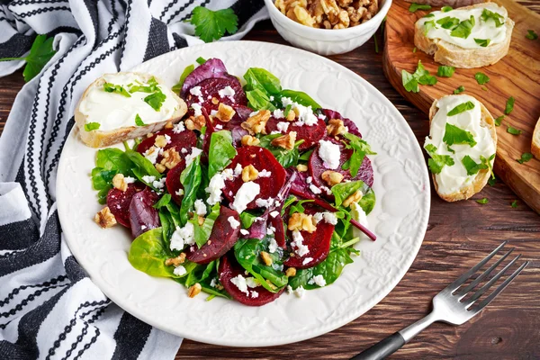 Healthy Beet Salad with fresh sweet baby spinach, kale lettuce, nuts, feta cheese and toast with melted cheese.
