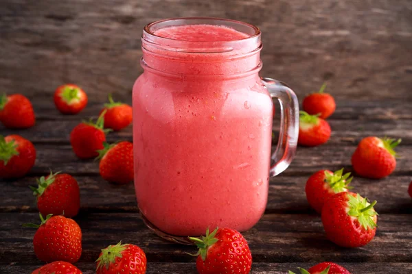 Strawberry smoothie in jar glass on wooden table. healthy food concept for breakfast or snack.