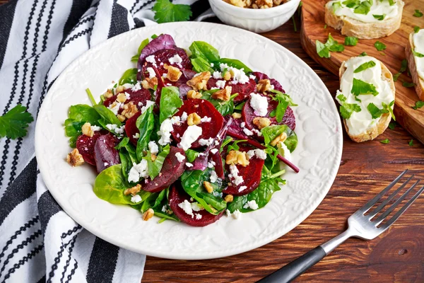 Healthy Beet Salad with fresh sweet baby spinach, kale lettuce, nuts, feta cheese and toast with melted cheese