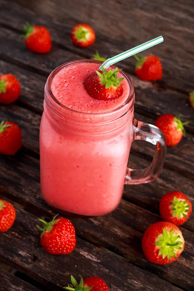 Strawberry smoothie in jar glass on wooden table. healthy food concept for breakfast or snack.
