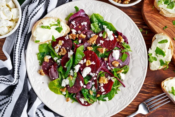 Healthy Beet Salad with fresh sweet baby spinach, kale lettuce, nuts, feta cheese and toast  melted