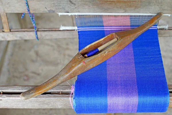 Wooden bobbin on ancient silk loom
