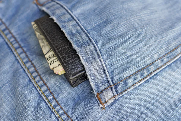 Old wallet in back pocket jeans