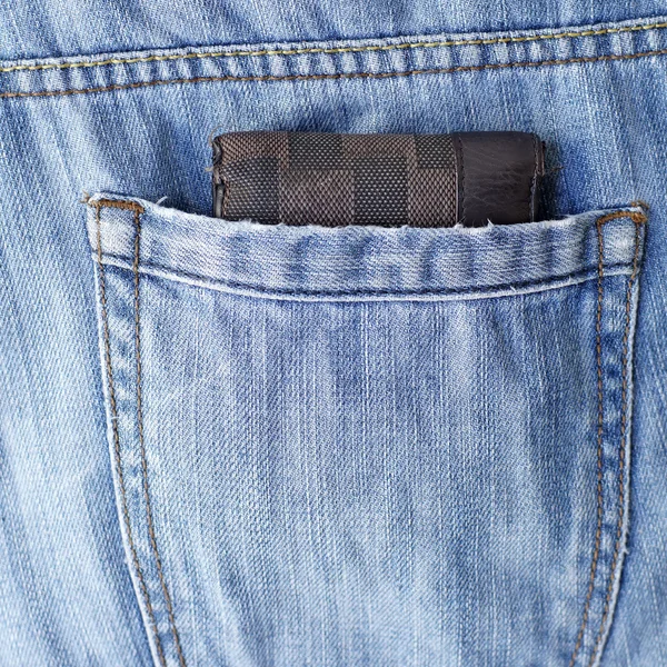 Old wallet in back pocket jeans