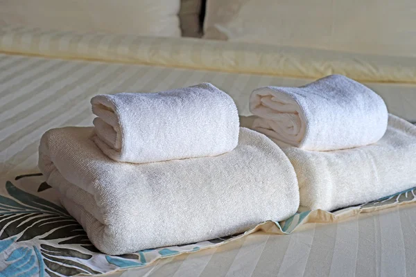 White bath towels rolled and piled