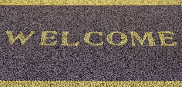 Welcome text on brown doormat