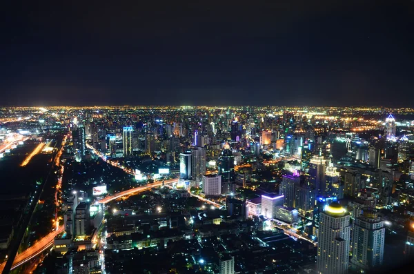 Birds eye view of a modern building at night. Traffic in the bus