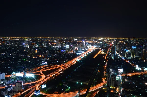 Birds eye view of a modern building at night. Traffic in the bus