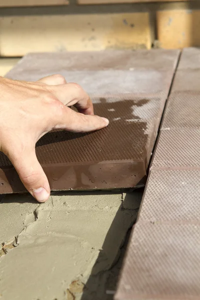 Process of creating Pavement tiles on cement.