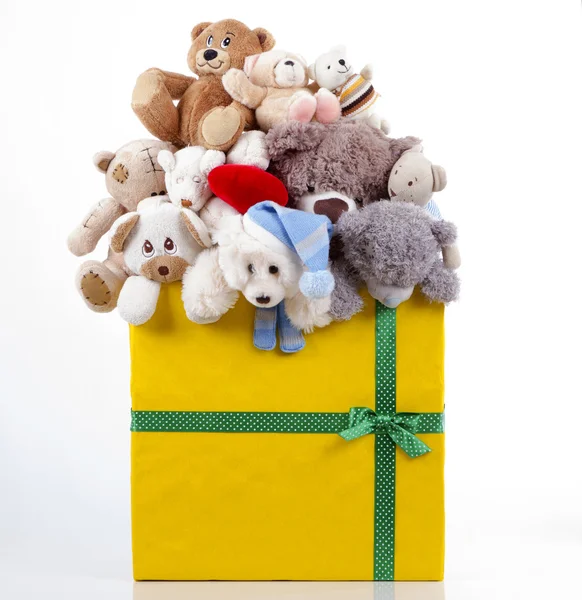 Many teddy bears of different sizes in a gift box