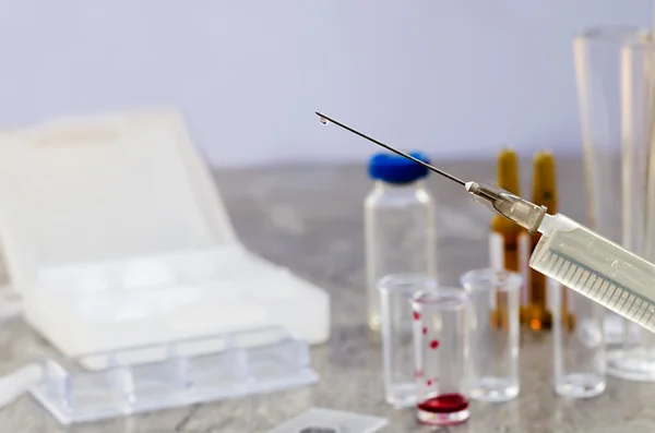 Syringe and vaccine front of a laboratory scene