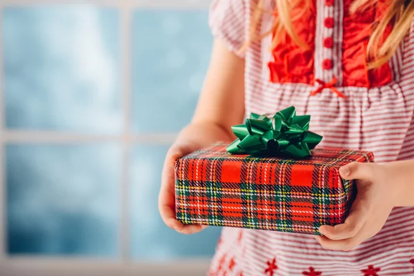 Christmas gift in the hands of a child. Shallow dof