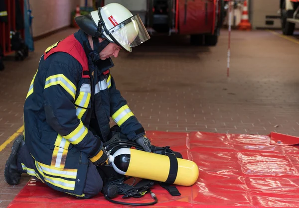 Firefighter with oxygen cylinder