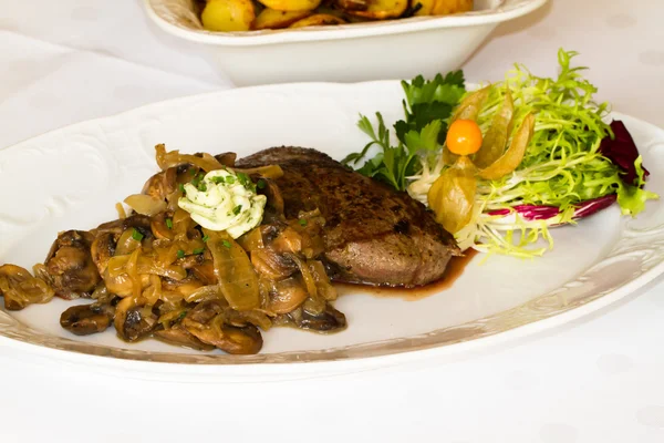 Fillet steak mushrooms and fried potatoes at the restaurant