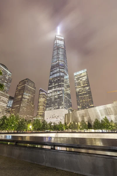 Night picture of The National September 11 Memorial pool and Freedom Tower.