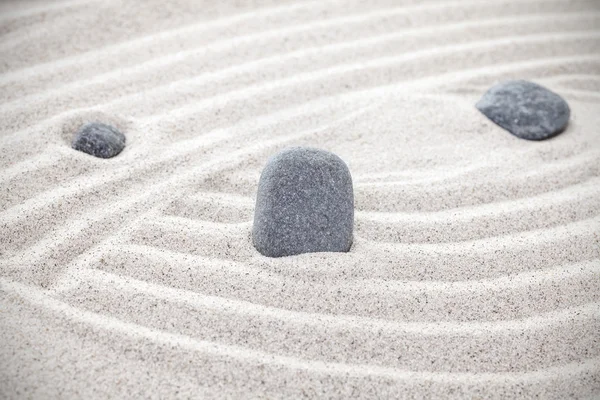 Three stones in sand, zen concept