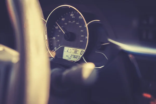Vintage toned car dashboard with 99 degrees Fahrenheit.