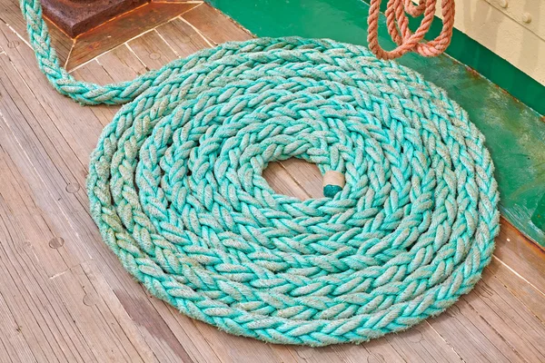 Mooring rope on wooden deck of a sailboat