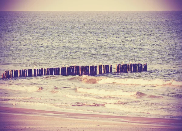 Vintage retro filtered picture of a beach, peaceful background.