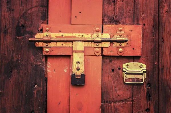 Retro vintage style picture of wooden door with lock.