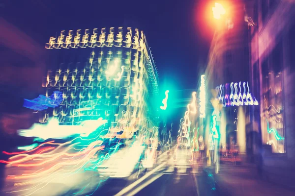 Retro filtered city traffic lights in motion blur.