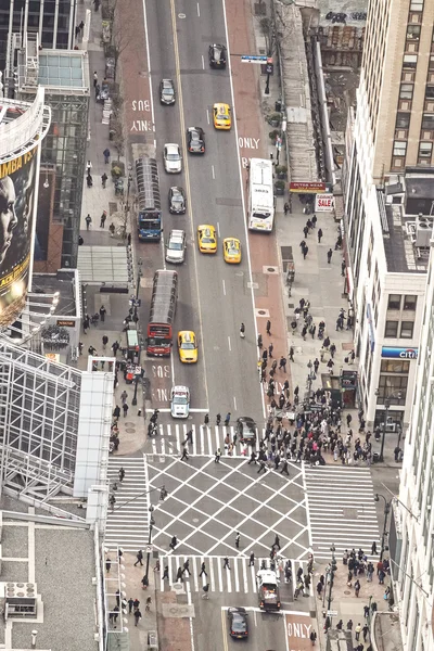 Aerial view of the city center filled with pedestrians and cars.