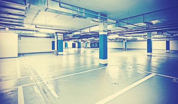 Instagram toned photo of underground parking, industrial backgro