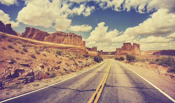 Vintage retro stylized scenic desert road, USA.