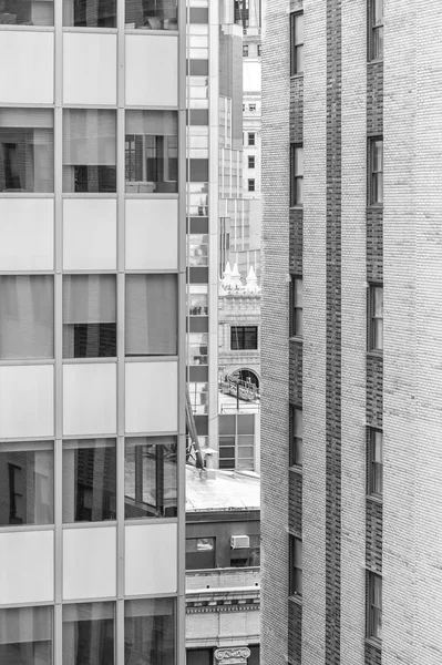 Black and white picture of modern and old high rise buildings.