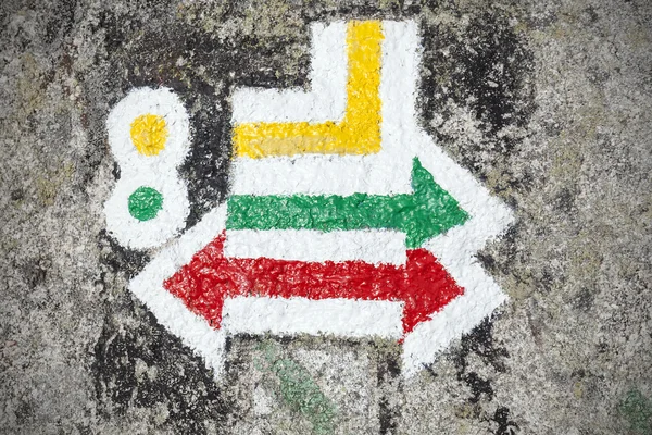 Hiking trails signs painted on rock.