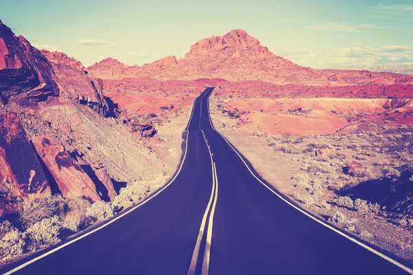 Vintage toned curved desert highway, travel concept, USA