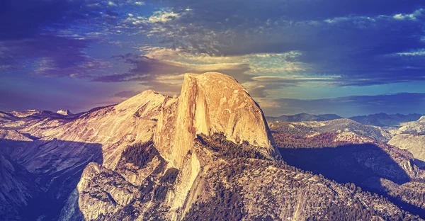 Vintage toned sunset above Half Dome rock.