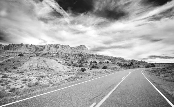 Black and white photo of a country road, travel concept