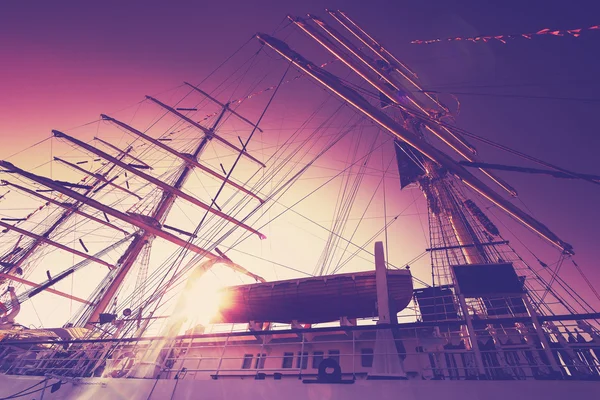 Vintage filtered an old sailing ship at sunrise