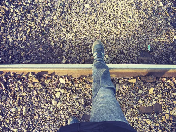 Vintage stylized legs walking on rail track, concept picture