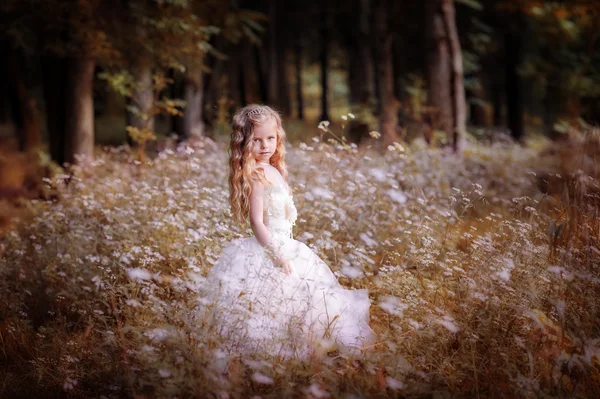 Little blond girl in white dress