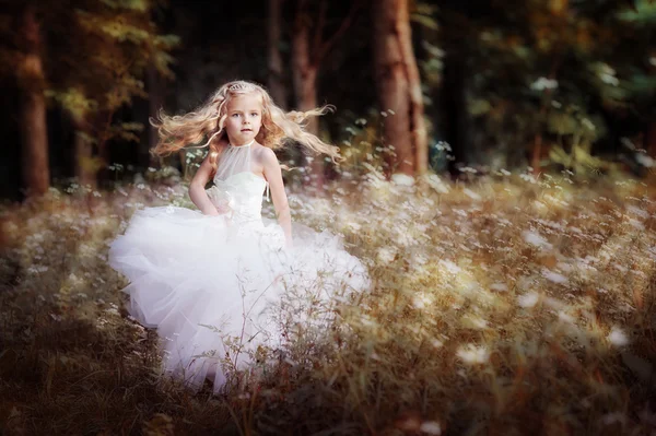 Little blond girl in white dress
